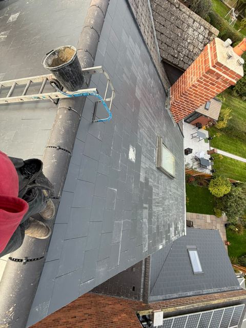 Finished new slate roof and ridge with a brick chimney