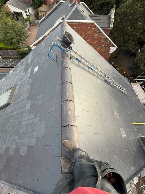 Finished new slate roof with ridge tiles and a roof window