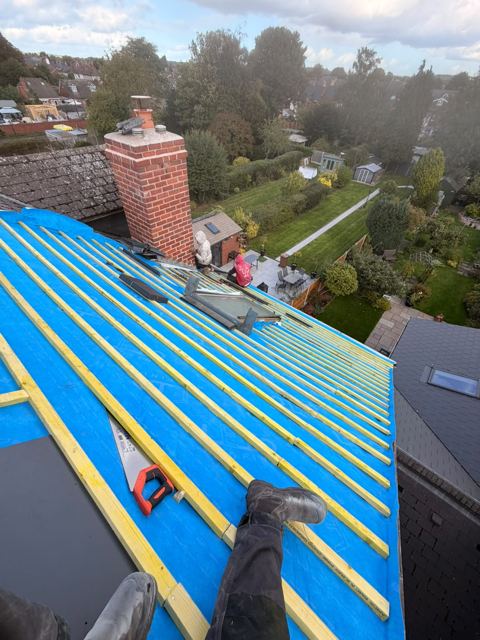 New roofing membrane and battens fixed on a roof beside a roof window